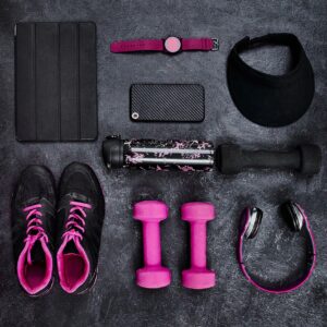 Blush-accent athleisure set flat lay on warm white background