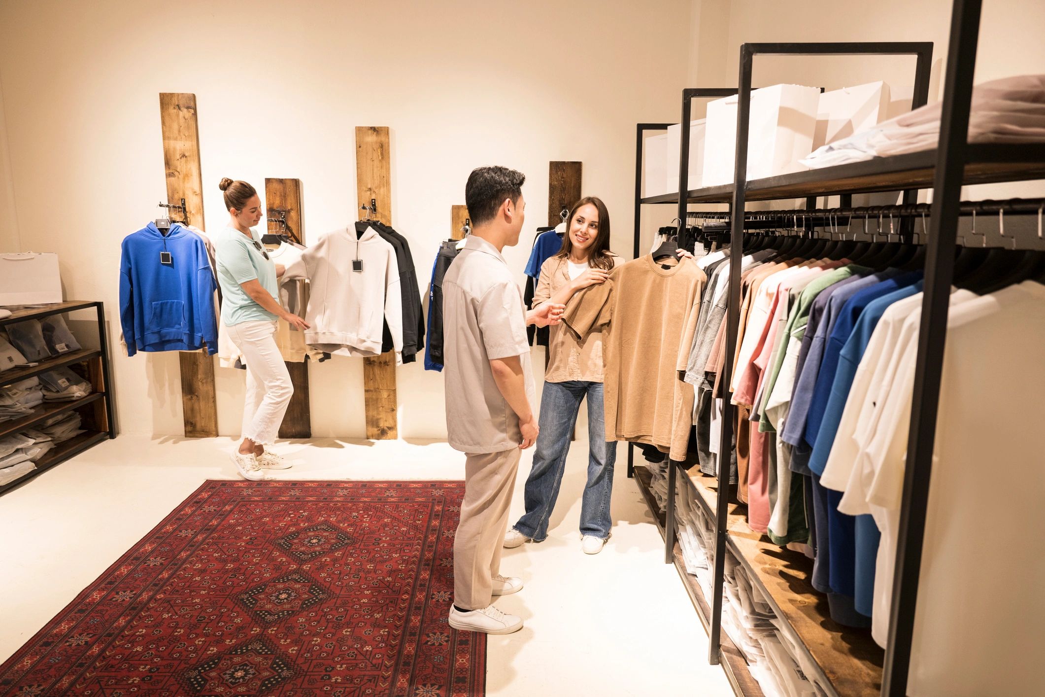Customers browsing clothing in a modern store