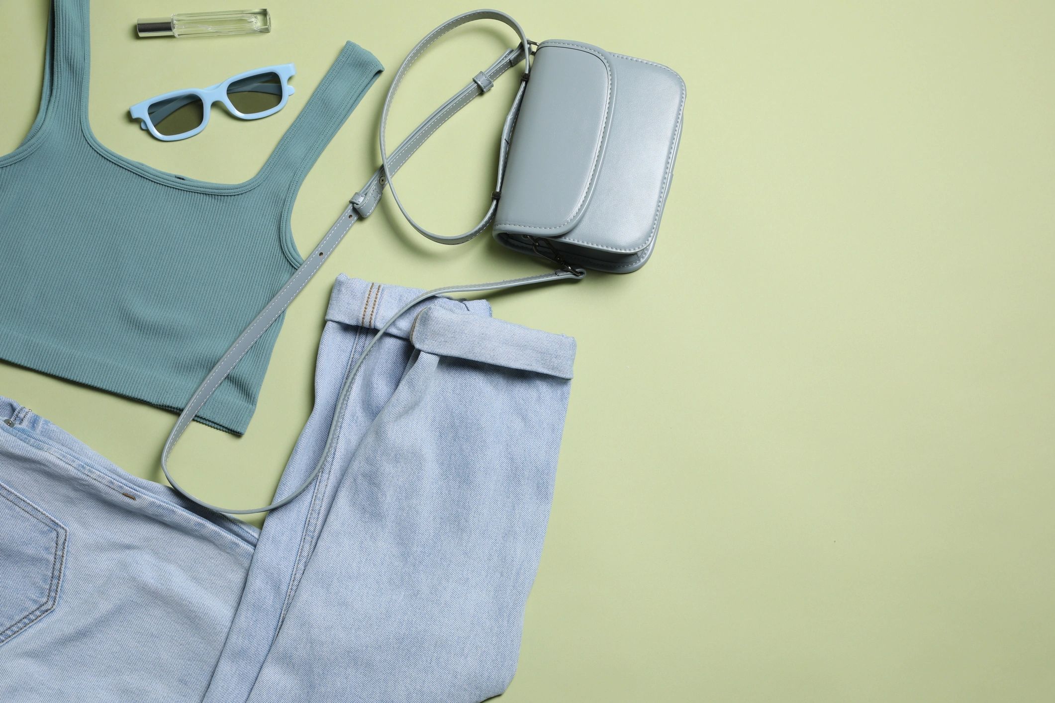 Flat lay of women’s clothing and accessories with space for text
